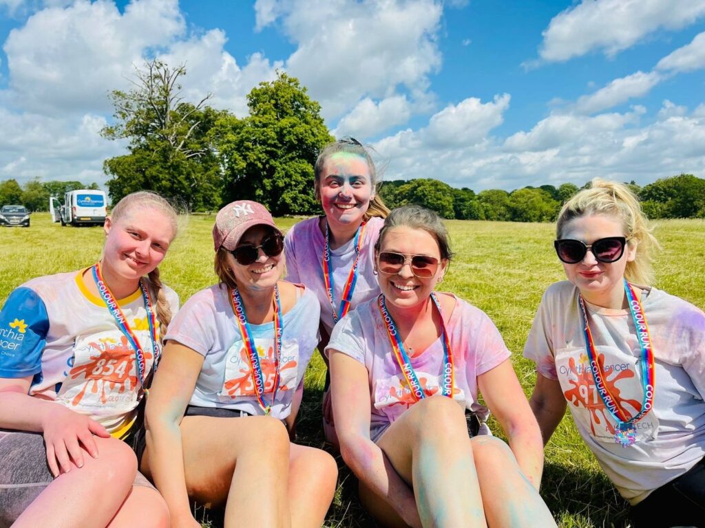 Employees post-run covered in coloured powder paint