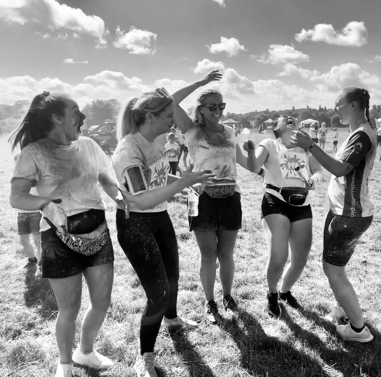 Black and white action shot of people celebrating and laughing.